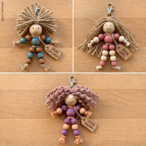 Real photo of three beaded doll keychains.